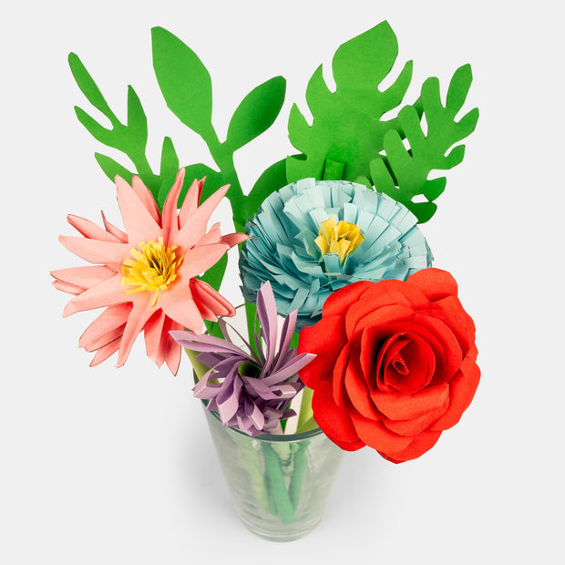 Cup of flowers and leaves made out of cute paper and assembled to make various flower kinds.