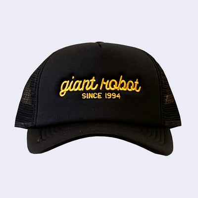Black colored hat with "giant robot" written along the front in yellow cursive, and "since 1994" written below in plain capital font.