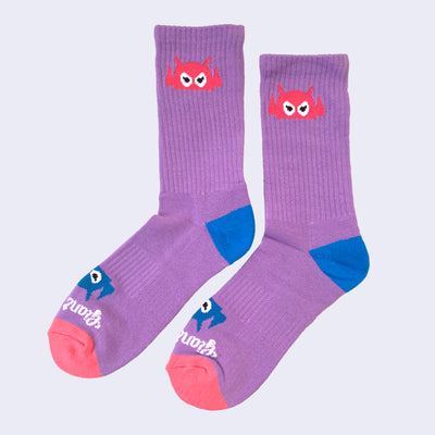 Vibrant lavender socks with a cartoon robot head. The robot decorates the cuff end of each sock so that it peeks out when you wear sneakers.