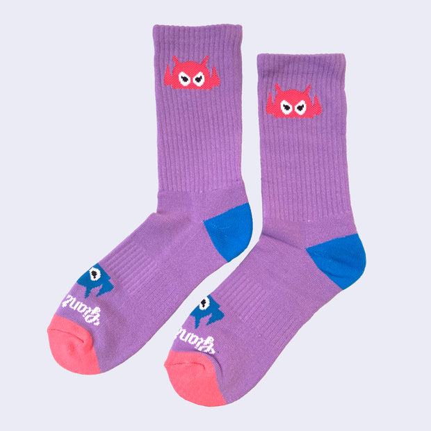 Vibrant lavender socks with a cartoon robot head. The robot decorates the cuff end of each sock so that it peeks out when you wear sneakers.