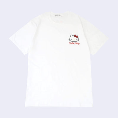 White t-shirt with an embroidery on the upper left chest area of Hello Kitty's face with her iconic red bow and her name written in red cursive below.