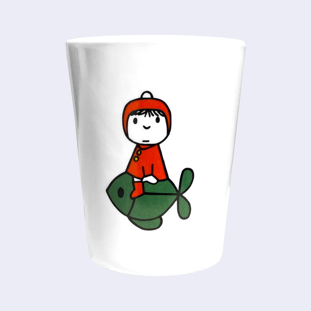 White plastic cup with a simple, cute illustration of a girl in a red coat and red hood. She rides atop of a green fish.