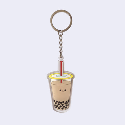 Die cut acrylic keychain of an illustrated milk tea boba cup with a small smiling cartoon style face in the center of the cup.
