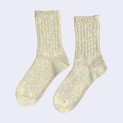 Cotton crew socks thickly knit with pastel green, yellow, pink and white thread. Each color is mixed.