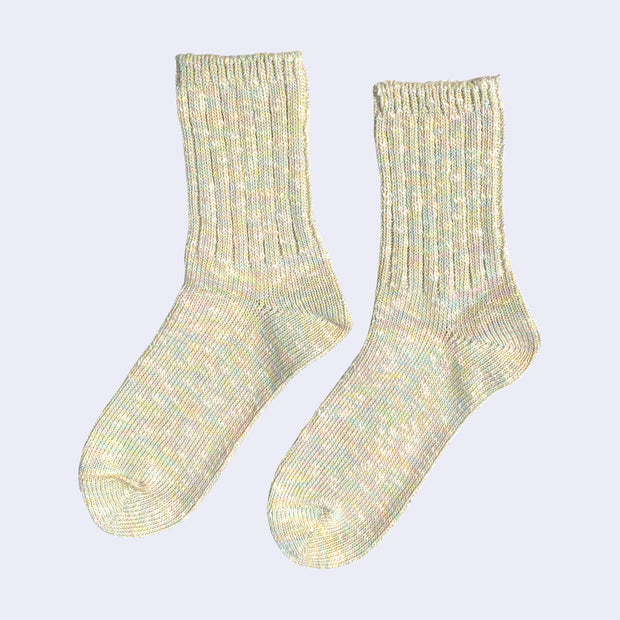 Cotton crew socks thickly knit with pastel green, yellow, pink and white thread. Each color is mixed.